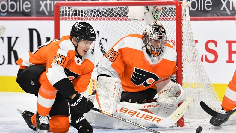 Mar 7, 2021; Philadelphia, Pennsylvania, USA; Philadelphia Flyers goaltender Carter Hart (79) and left wing Oskar Lindblom (23) makes a save against the Washington Capitals during the third period at Wells Fargo Center. Mandatory Credit: Eric Hartline-USA TODAY Sports