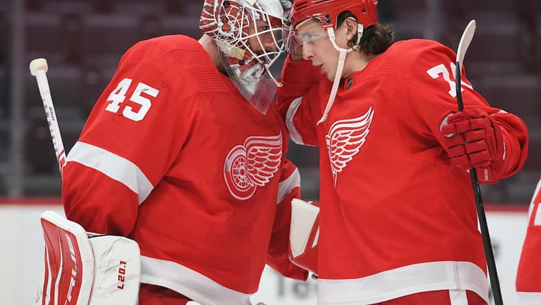 Mar 11, 2021; Detroit, Michigan, USA; Detroit Red Wings goaltender Jonathan Bernier (45) and defenseman Troy Stecher (70) celebrate after the game against the Tampa Bay Lightning at Little Caesars Arena. Mandatory Credit: Tim Fuller-USA TODAY Sports