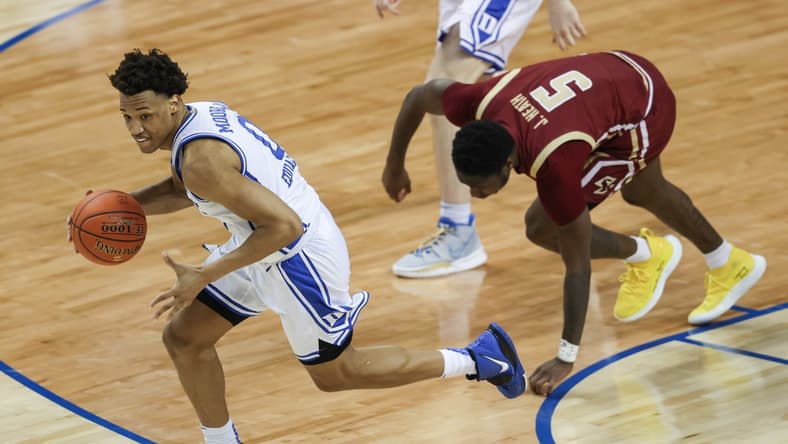 Mar 9, 2021; Greensboro, North Carolina, USA; Duke Blue Devils forward Wendell Moore Jr. (0) pushes the ball upcourt ahead of Boston College Eagles guard Jay Heath (5) in the first round of the 2021 ACC men's basketball tournament at Greensboro Coliseum. Mandatory Credit: Nell Redmond-USA TODAY Sports