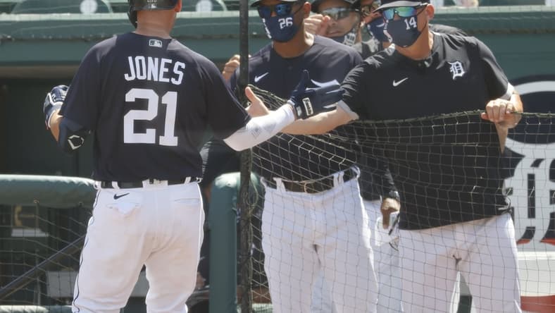 Mar 16, 2021; Lakeland, Florida, USA;  Detroit Tigers left fielder JaCoby Jones (21) is congratulated by manager A.J. Hinch (14) as je hits a home run during the second inning against the New York Yankees at Publix Field at Joker Marchant Stadium. Mandatory Credit: Kim Klement-USA TODAY Sports