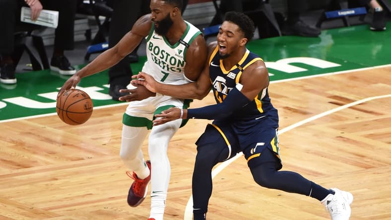 Mar 16, 2021; Boston, Massachusetts, USA; Boston Celtics guard Jaylen Brown (7) controls the ball against Utah Jazz guard Donovan Mitchell (45) during the first half at TD Garden. Mandatory Credit: Bob DeChiara-USA TODAY Sports