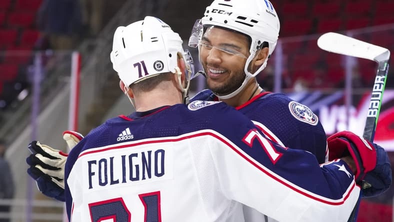 Mar 18, 2021; Raleigh, North Carolina, USA; Columbus Blue Jackets defenseman Seth Jones (3) is congratulated by left wing Nick Foligno (71) after his game winning overtime goal against the Carolina Hurricanes at PNC Arena. Mandatory Credit: James Guillory-USA TODAY Sports