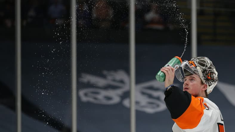 Mar 20, 2021; Uniondale, New York, USA; Philadelphia Flyers goalie Carter Hart (79) sprays water before taking a drink during the second period against the New York Islanders at Nassau Veterans Memorial Coliseum. Mandatory Credit: Brad Penner-USA TODAY Sports