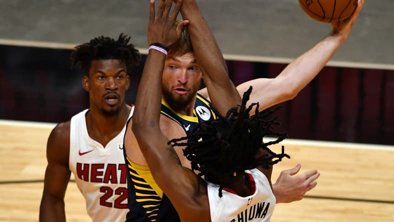 Mar 21, 2021; Miami, Florida, USA; Indiana Pacers forward Domantas Sabonis (11) looks to pass as Miami Heat forward Jimmy Butler (22) and forward Precious Achiuwa (5) defend on the play in the first quarter at American Airlines Arena. Mandatory Credit: Jim Rassol-USA TODAY Sports