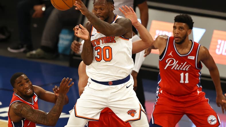 Mar 21, 2021; New York, New York, USA;  Julius Randle #30 of the New York Knicks passes the ball as Tony Bradley #11 and Shake Milton #18 of the Philadelphia 76ers defend in the second quarter at Madison Square Garden on March 21, 2021 in New York City.  Mandatory Credit: Elsa/Pool Photo-USA TODAY Sports
