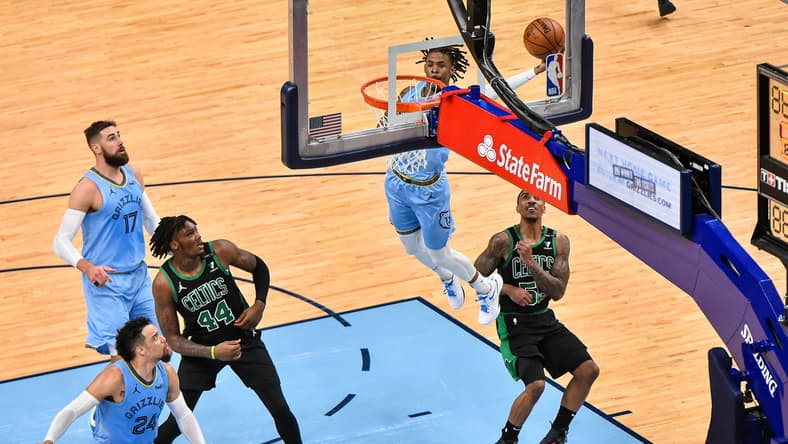 Mar 22, 2021; Memphis, Tennessee, USA; Memphis Grizzlies guard Ja Morant (12) dunks against Boston Celtics guard Jeff Teague (55) during the second half at FedExForum. Mandatory Credit: Justin Ford-USA TODAY Sports