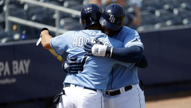 Mar 26, 2021; Port Charlotte, Florida, USA; Tampa Bay Rays first baseman Yandy D az (2) is congratulated after hitting a home run during the third inning against the Boston Red Sox at Charlotte Sports Park. Mandatory Credit: Kim Klement-USA TODAY Sports