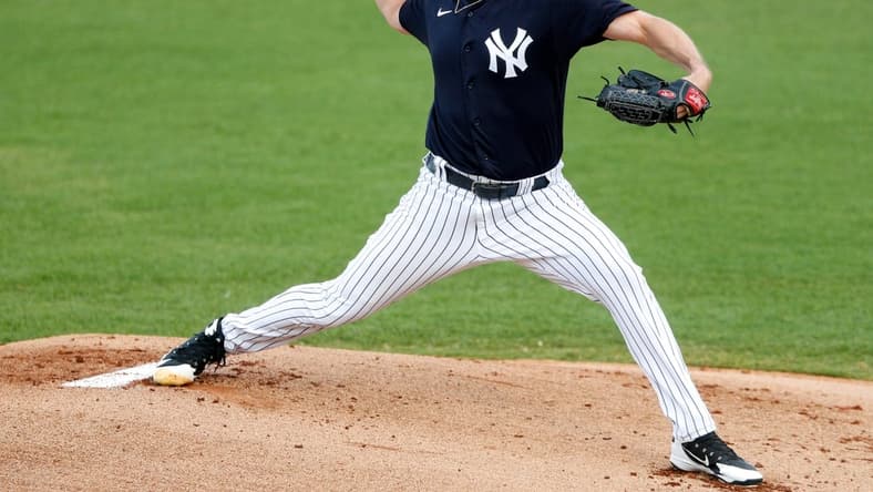 Mar 26, 2021; Tampa, Florida, USA;  New York Yankees starting pitcher Gerrit Cole (45) pitches in the first inning against the Baltimore Orioles during spring training at George M. Steinbrenner Field. Mandatory Credit: Nathan Ray Seebeck-USA TODAY Sports