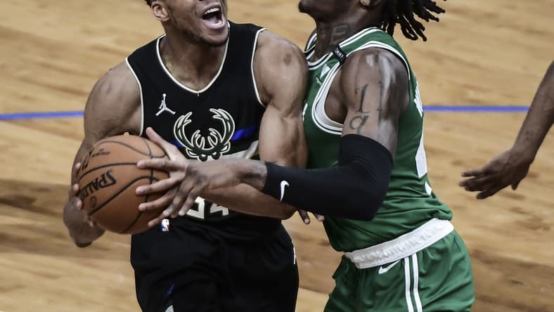 Mar 26, 2021; Milwaukee, Wisconsin, USA; Milwaukee Bucks forward Giannis Antetokounmpo (34) looks for a shot against Boston Celtics center Robert Williams III (44) in the third quarter at Fiserv Forum. Mandatory Credit: Benny Sieu-USA TODAY Sports