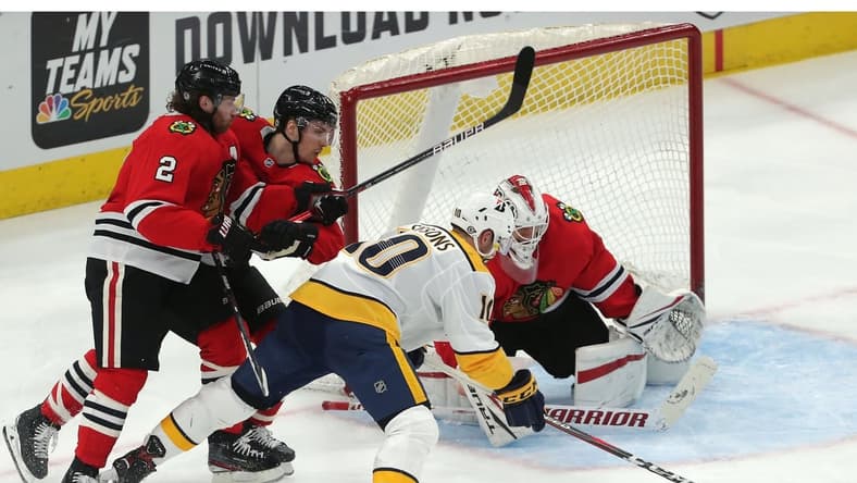 Mar 27, 2021; Chicago, Illinois, USA; Nashville Predators center Colton Sissons (10) moves in on Chicago Blackhawks goaltender Kevin Lankinen (32) during the second period at the United Center. Mandatory Credit: Dennis Wierzbicki-USA TODAY Sports