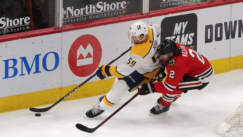 Mar 27, 2021; Chicago, Illinois, USA; Chicago Blackhawks defenseman Duncan Keith (2) and Nashville Predators defenseman Roman Josi (59) chase the puck behind the net during the third period at the United Center. Mandatory Credit: Dennis Wierzbicki-USA TODAY Sports