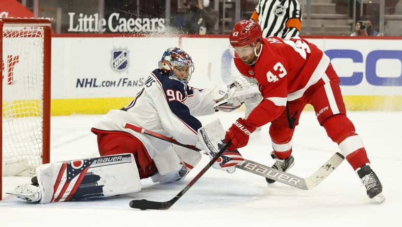 Mar 28, 2021; Detroit, Michigan, USA;  Detroit Red Wings left wing Darren Helm (43) shoots the puck on Columbus Blue Jackets goaltender Elvis Merzlikins (90) in the second period at Little Caesars Arena. Mandatory Credit: Rick Osentoski-USA TODAY Sports
