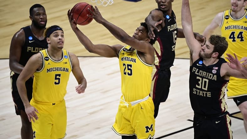 Mar 28, 2021; Indianapolis, IN, USA; Michigan Wolverines guard Jace Howard (25) shoots the ball against Florida State Seminoles center Quincy Ballard (15) and forward Harrison Prieto (30) in the second half during the Sweet 16 of the 2021 NCAA Tournament at Bankers Life Fieldhouse. Mandatory Credit: Marc Lebryk-USA TODAY Sports