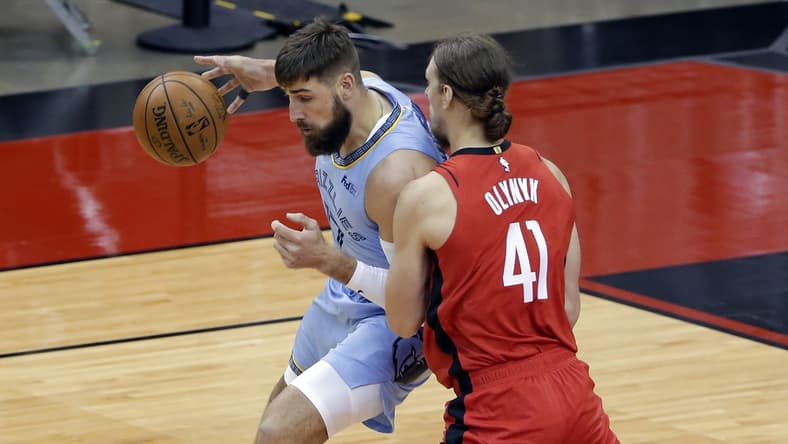 Mar 29, 2021; Houston, Texas, USA; Memphis Grizzlies center Jonas Valanciunas (left) tries to drive around Houston Rockets forward Kelly Olynyk (41) during the first half at Toyota Center. Mandatory Credit:  Michael Wyke/POOL PHOTOS-USA TODAY Sports