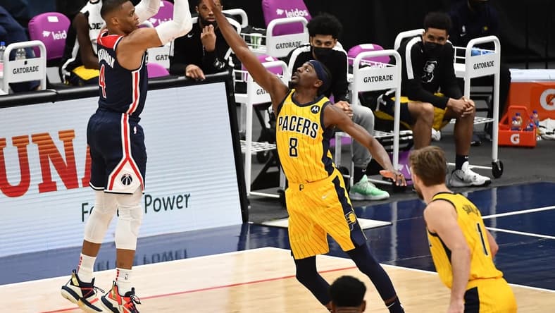 Mar 29, 2021; Washington, District of Columbia, USA; Washington Wizards guard Russell Westbrook (4) shoots the ball over Indiana Pacers forward Justin Holiday (8) during the fourth quarter at Capital One Arena. Mandatory Credit: Brad Mills-USA TODAY Sports