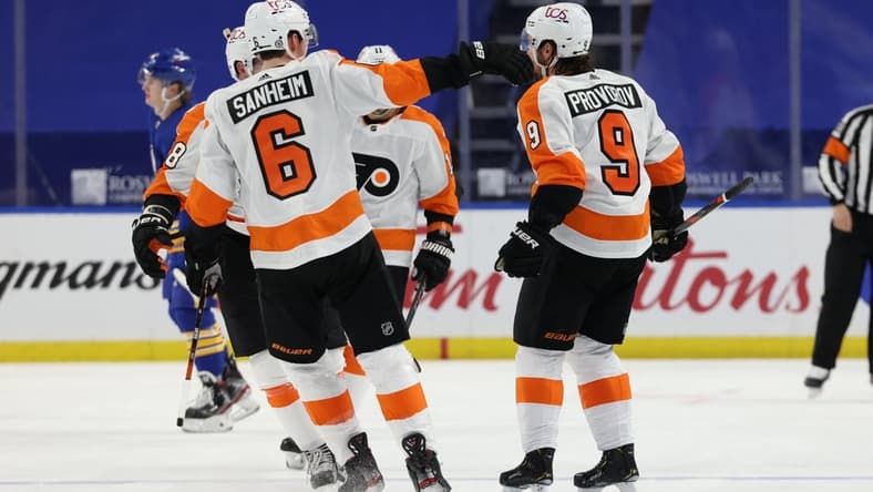 Mar 29, 2021; Buffalo, New York, USA; Philadelphia Flyers defenseman Ivan Provorov (9) celebrates with teammates after scoring an overtime goal against the Buffalo Sabres at KeyBank Center. Mandatory Credit: Timothy T. Ludwig-USA TODAY Sports