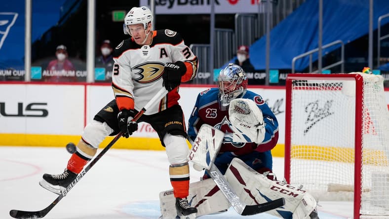 Mar 29, 2021; Denver, Colorado, USA; Anaheim Ducks right wing Jakob Silfverberg (33) attempts to redirect the puck past Colorado Avalanche goaltender Philipp Grubauer (31) in the first period at Ball Arena. Mandatory Credit: Isaiah J. Downing-USA TODAY Sports