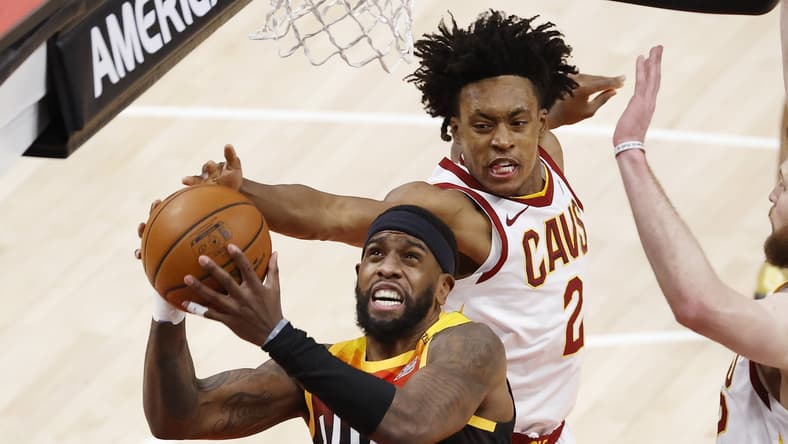 Mar 29, 2021; Salt Lake City, Utah, USA; Utah Jazz forward Royce O'Neale (23) and Cleveland Cavaliers guard Collin Sexton (2) battle in the second quarter at Vivint Smart Home Arena. Mandatory Credit: Jeffrey Swinger-USA TODAY Sports