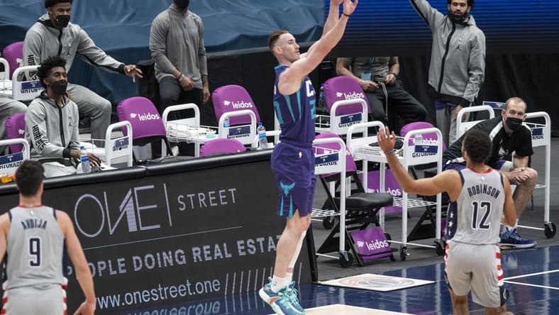 Mar 30, 2021; Washington, District of Columbia, USA;  Charlotte Hornets forward Gordon Hayward (20) takes a three point shot as Washington Wizards guard Jerome Robinson (12) defends during the first half at Capital One Arena. Mandatory Credit: Tommy Gilligan-USA TODAY Sports