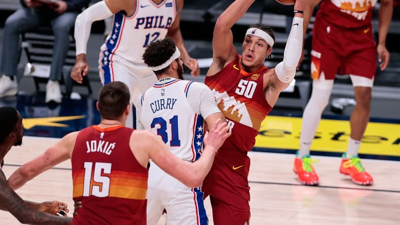 Mar 30, 2021; Denver, Colorado, USA; Denver Nuggets forward Aaron Gordon (50) corns the ball against Philadelphia 76ers guard Seth Curry (31) in the second quarter at Ball Arena. Mandatory Credit: Isaiah J. Downing-USA TODAY Sports