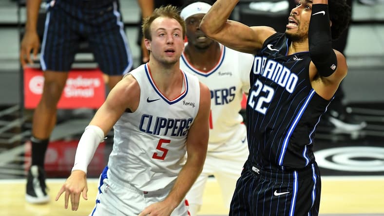 Mar 30, 2021; Los Angeles, California, USA; Orlando Magic forward Otto Porter Jr. (22) goes to the basket as Los Angeles Clippers guard Luke Kennard (5) looks on during the first half at Staples Center. Mandatory Credit: Jayne Kamin-Oncea-USA TODAY Sports