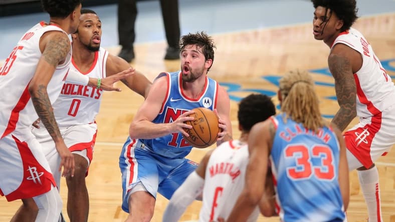 Mar 31, 2021; Brooklyn, New York, USA; Brooklyn Nets small forward Joe Harris (12) controls the ball against Houston Rockets center Christian Wood (35) and power forward D.J. Wilson (0) during the second quarter at Barclays Center. Mandatory Credit: Brad Penner-USA TODAY Sports
