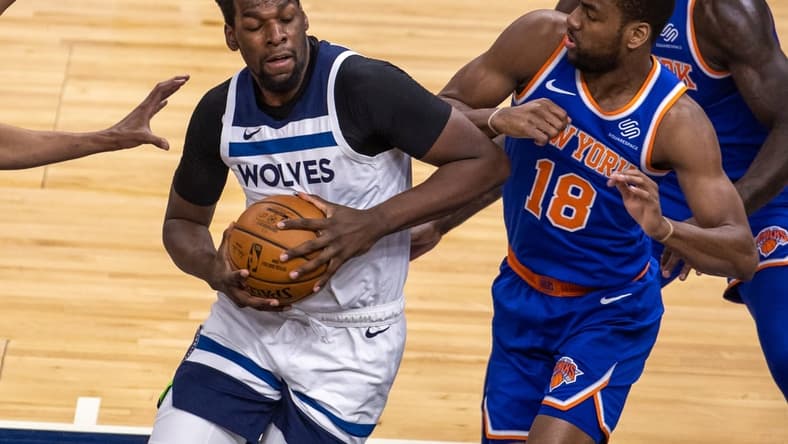 Mar 31, 2021; Minneapolis, Minnesota, USA; Minnesota Timberwolves center Naz Reid (11) drives towards the basket as New York Knicks guard Alec Burks (18) plays defense in the first half at Target Center. Mandatory Credit: Jesse Johnson-USA TODAY Sports