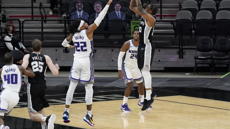 Mar 31, 2021; San Antonio, Texas, USA; San Antonio Spurs forward DeMar DeRozan (10) shoots the ball over Sacramento Kings forward Richaun Holmes (22) as guard Buddy Hield (24) looks on during the third quarter at AT&T Center. Mandatory Credit: Scott Wachter-USA TODAY Sports
