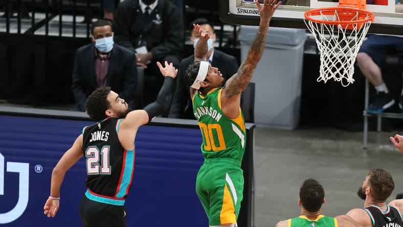 Mar 31, 2021; Memphis, Tennessee, USA; Utah Jazz guard Jordan Clarkson (00) shoots the ball while defended by Memphis Grizzlies guard Tyus Jones (21) during the fourth quarter at FedExForum. Mandatory Credit: Nelson Chenault-USA TODAY Sports