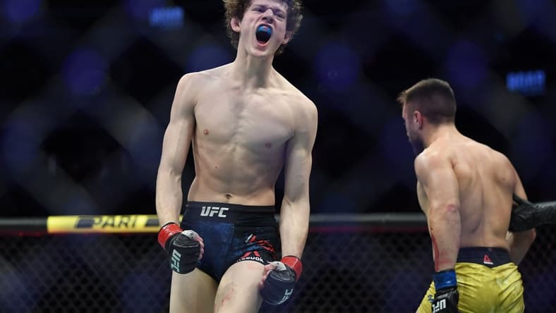 Dec 14, 2019; Las Vegas, NV, USA; Chase Hooper (red gloves) reacts during his bout against Daniel Teymur (blue gloves) during UFC 245 at T-Mobile Arena. Mandatory Credit: Stephen R. Sylvanie-USA TODAY Sports