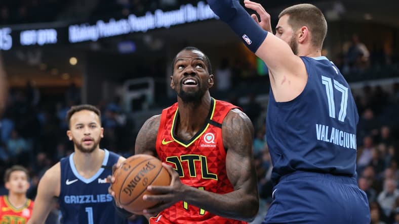 Mar 7, 2020; Memphis, Tennessee, USA; Atlanta Hawks center Dewayne Dedmon (14) drives against Memphis Grizzlies center Jonas Valanciunas (17) as Memphis forward Kyle Anderson (1) looks on at FedExForum. Mandatory Credit: Nelson Chenault-USA TODAY Sports