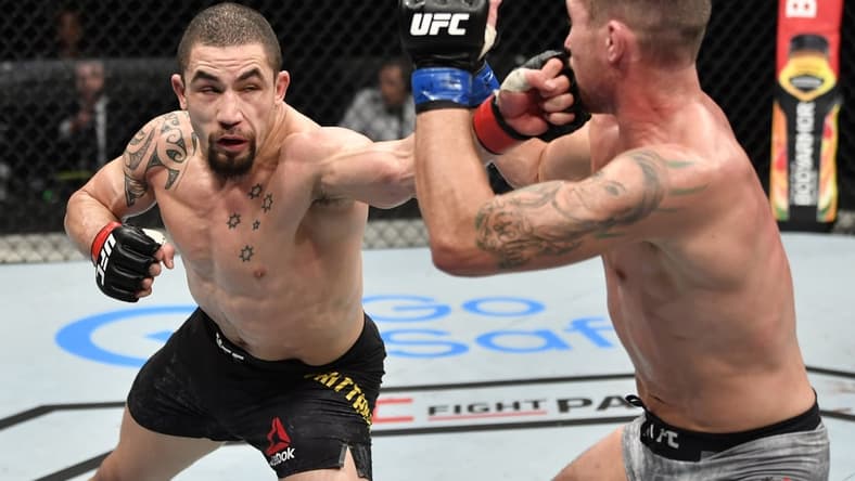July 26, 2020; Abu Dhabi, UAE; Robert Whittaker (red gloves) of New Zealand punches Darren Till (blue gloves) of England in their middleweight fight during the UFC Fight Night event inside Flash Forum on UFC Fight Island.  Mandatory Credit: Jeff Bottari/Zuffa LLC via USA TODAY Sports