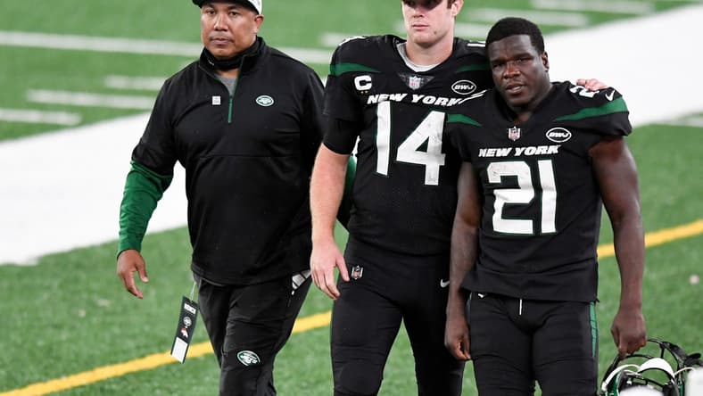 (from left) Offensive coach Hines Ward, New York Jets quarterback Sam Darnold (14), and running back Frank Gore (21) walk off the field after losing to the Denver Broncos, 37-28, at MetLife Stadium on Thursday, Oct. 1, 2020, in East Rutherford.

Nfl Jets Broncos