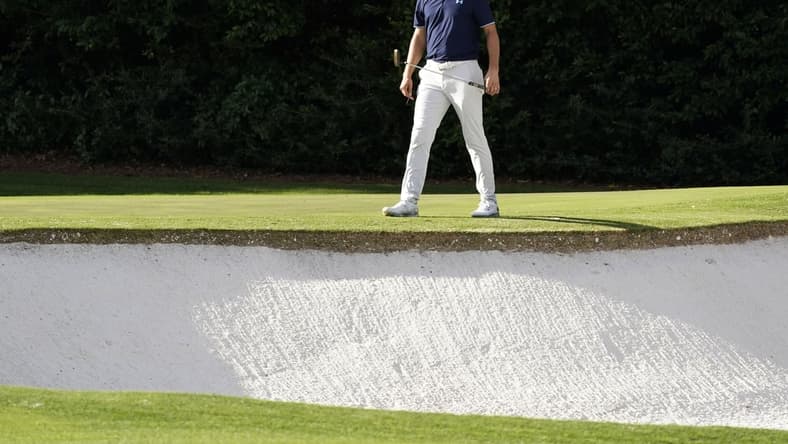 Nov 10, 2020; Augusta, Georgia, USA; Jordan Spieth surveys the bunker at the fourth green during a practice round for The Masters golf tournament at Augusta National GC. Mandatory Credit: Rob Schumacher-USA TODAY Sports