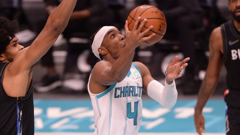 Dec 27, 2020; Charlotte, North Carolina, USA;  Charlotte Hornets guard Devonte' Graham (4) drives in during the second half against the Brooklyn Nets at the Spectrum Center. Hornets won 106-104. Mandatory Credit: Sam Sharpe-USA TODAY Sports