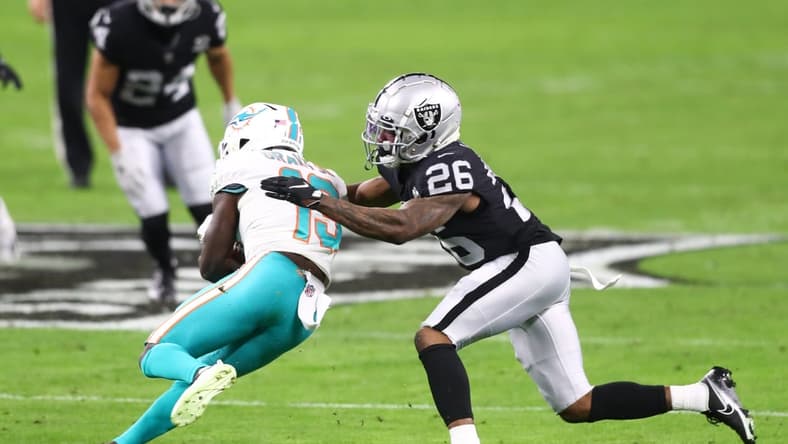 Dec 26, 2020; Paradise, Nevada, USA; Miami Dolphins wide receiver Jakeem Grant (19) is tackled by Las Vegas Raiders cornerback Nevin Lawson (26) at Allegiant Stadium. Mandatory Credit: Mark J. Rebilas-USA TODAY Sports