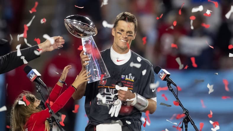 Feb 7, 2021; Tampa, FL, USA; Confetti falls as Tampa Bay Buccaneers quarterback Tom Brady (12) celebrates with the Vince Lombardi Trophy after beating the Kansas City Chiefs in Super Bowl LV at Raymond James Stadium. Mandatory Credit: Mark J. Rebilas-USA TODAY Sports