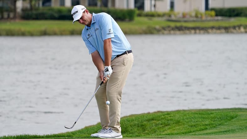 Mar 18, 2021; Palm Beach Gardens, Florida, USA; Sepp Straka chips onto the 18th green during the first round of The Honda Classic golf tournament at PGA National (Champion). Mandatory Credit: Jasen Vinlove-USA TODAY Sports