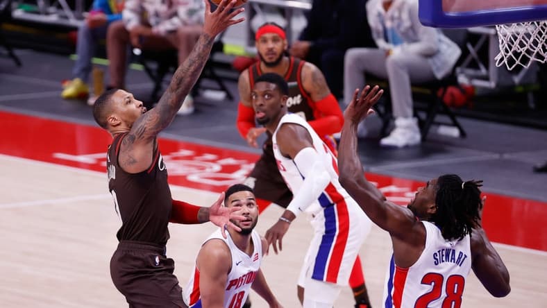 Mar 31, 2021; Detroit, Michigan, USA;  Portland Trail Blazers guard Damian Lillard (0) shoots on Detroit Pistons center Isaiah Stewart (28) in the second half at Little Caesars Arena. Mandatory Credit: Rick Osentoski-USA TODAY Sports