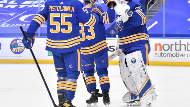 Mar 31, 2021; Buffalo, New York, USA; Buffalo Sabres defenseman Rasmus Ristolainen (55) and defenseman Colin Miller (33) celebrate with goaltender Linus Ullmark (35) after defeating the Philadelphia Flyers at KeyBank Center. Mandatory Credit: Mark Konezny-USA TODAY Sports
