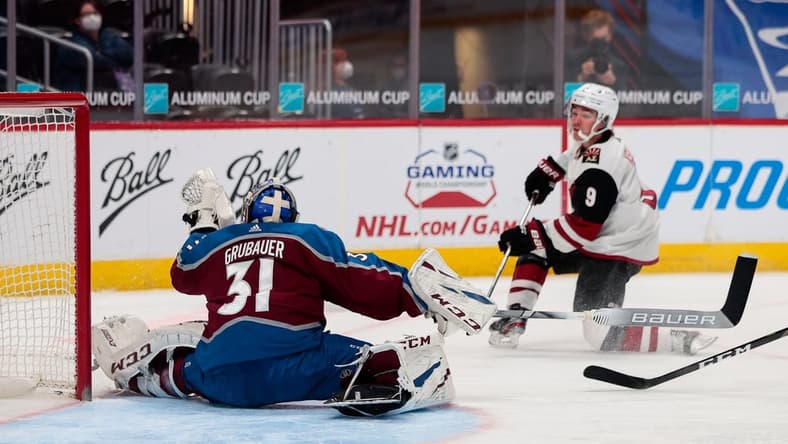 Mar 31, 2021; Denver, Colorado, USA; Colorado Avalanche goaltender Philipp Grubauer (31) makes a save on a shot from Arizona Coyotes right wing Clayton Keller (9) in the second period at Ball Arena. Mandatory Credit: Isaiah J. Downing-USA TODAY Sports