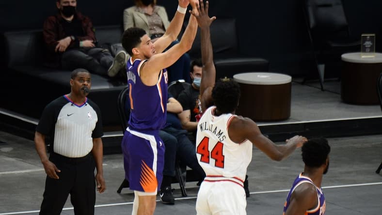 Mar 31, 2021; Phoenix, Arizona, USA; Phoenix Suns guard Devin Booker (1) shoots over Chicago Bulls forward Patrick Williams (44) during the second half at Phoenix Suns Arena. Mandatory Credit: Joe Camporeale-USA TODAY Sports
