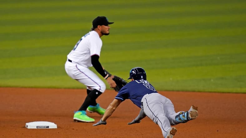 Apr 1, 2021; Miami, Florida, USA; Tampa Bay Rays second baseman Brandon Lowe (8) dives into second base for a double in the 4th inning against the Miami Marlins at loanDepot park. Mandatory Credit: Jasen Vinlove-USA TODAY Sports