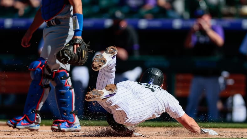 Apr 1, 2021; Denver, Colorado, USA; Colorado Rockies second baseman Chris Owings (12) slides into home for a run in the third inning against the Los Angeles Dodgers at Coors Field. Mandatory Credit: Isaiah J. Downing-USA TODAY Sports