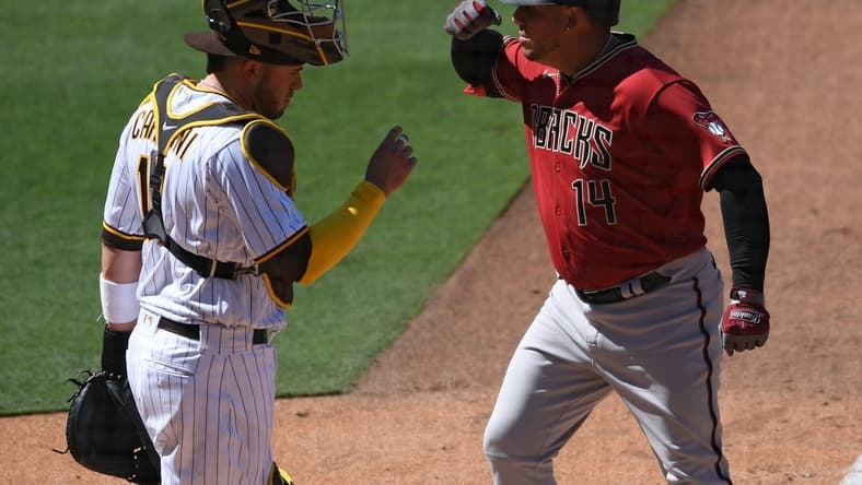 Apr 1, 2021; San Diego, California, USA; Arizona Diamondbacks third baseman Asdrubal Cabrera (14) gestures after hitting a two-run home run as San Diego Padres catcher Victor Caratini (17) looks on during the fifth inning at Petco Park. Mandatory Credit: Orlando Ramirez-USA TODAY Sports
