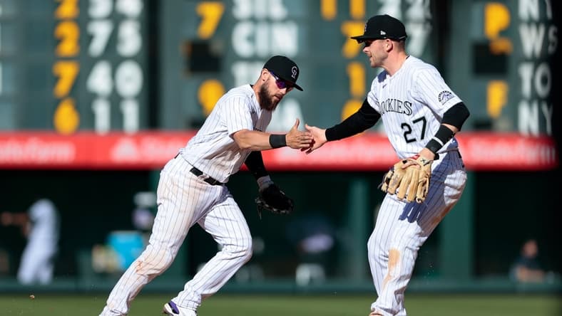 Apr 1, 2021; Denver, Colorado, USA; Colorado Rockies second baseman Chris Owings (12) celebrates with shortstop Trevor Story (27) after turning a double play in the seventh inning against the Los Angeles Dodgers at Coors Field. Mandatory Credit: Isaiah J. Downing-USA TODAY Sports