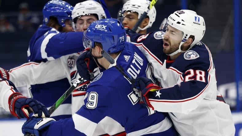 Apr 1, 2021; Tampa, Florida, USA; Columbus Blue Jackets right wing Oliver Bjorkstrand (28) and Tampa Bay Lightning left wing Ross Colton (79) and teammates defend each other during the first period at Amalie Arena. Mandatory Credit: Kim Klement-USA TODAY Sports