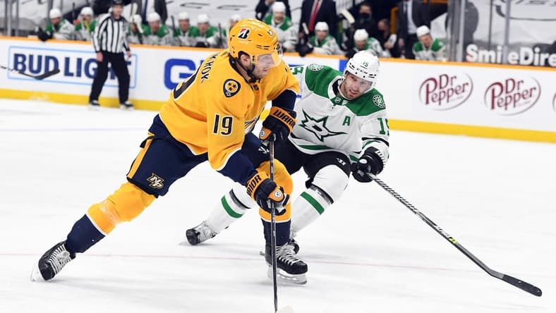 Apr 1, 2021; Nashville, Tennessee, USA; Nashville Predators center Calle Jarnkrok (19) shoots ahead of pressure from Dallas Stars left wing Blake Comeau (15) during the first period at Bridgestone Arena. Mandatory Credit: Christopher Hanewinckel-USA TODAY Sports