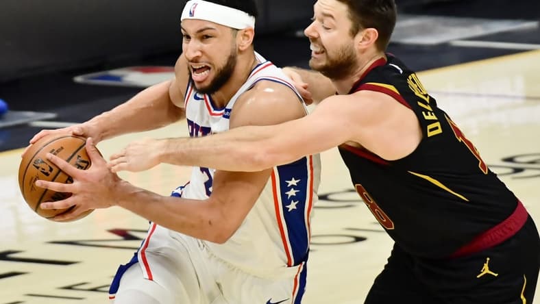Apr 1, 2021; Cleveland, Ohio, USA; Cleveland Cavaliers guard Matthew Dellavedova (18) fouls Philadelphia 76ers guard Ben Simmons (25) during the third quarter at Rocket Mortgage FieldHouse. Mandatory Credit: Ken Blaze-USA TODAY Sports