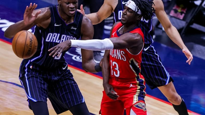 Apr 1, 2021; New Orleans, Louisiana, USA; New Orleans Pelicans guard Kira Lewis Jr. (13) passes the ball against Orlando Magic forward Chuma Okeke (3) during the first half at the Smoothie King Center. Mandatory Credit: Stephen Lew-USA TODAY Sports
